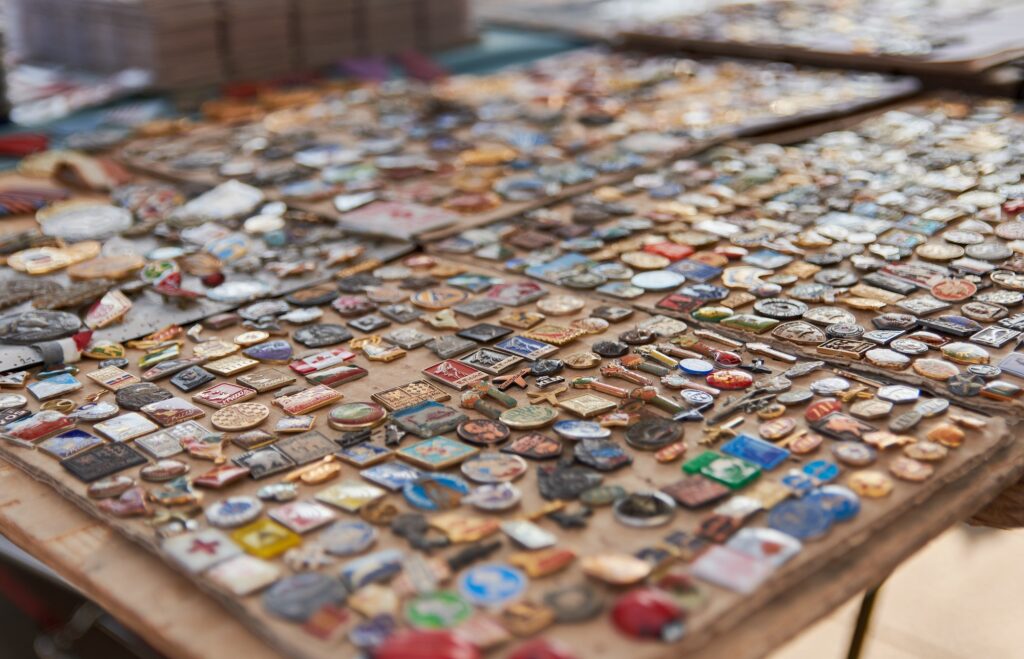 Selective focus of vintage badges for sale on street market.